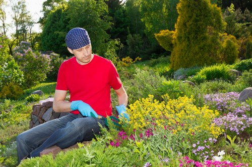 Surbiton gardeners planting vibrant flowers in a garden